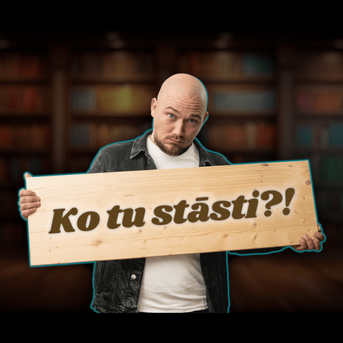 Vīrietis tur koka dēli ar uzrakstu "Ko tu stāsti?!"